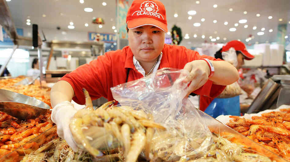 A fishmonger prepares her wares at the Sydney Fish Market.
