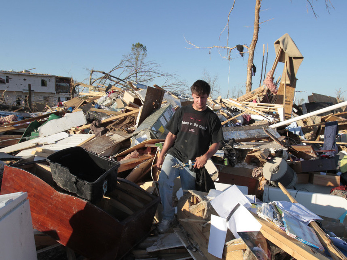 Tornado survivor Jonathan Ford saves what he can from his home April 29, 2011, after it was destroyed by a powerful tornado in Pleasant Grove, Ala.
