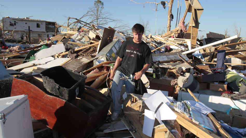 Tornado survivor Jonathan Ford saves what he can from his home April 29, 2011, after it was destroyed by a powerful tornado in Pleasant Grove, Ala.