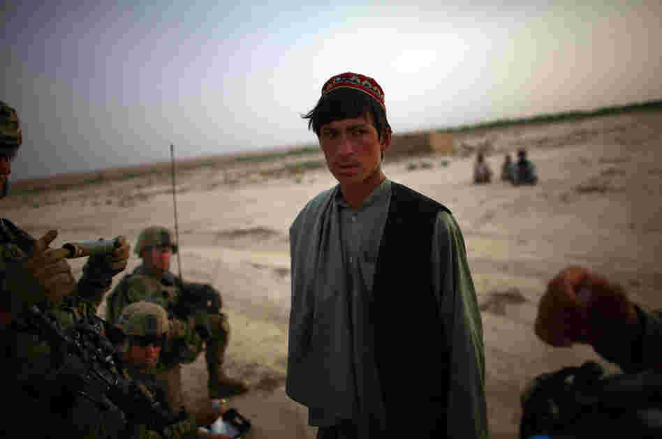 An Afghan man is questioned as he is entered into a biometric identification system — a database of every person the soldiers encounter in the field.
