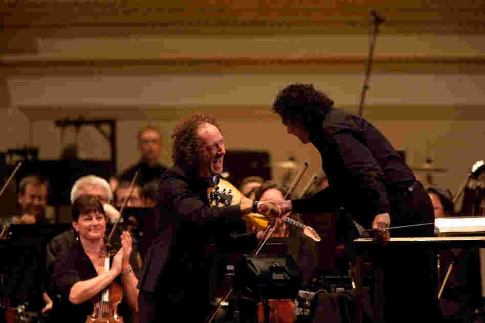 Tracy Silverman shakes hands with conductor Giancarlo Guerrero. Silverman says Riley's concerto is "a mashup of raga and ragtime." 