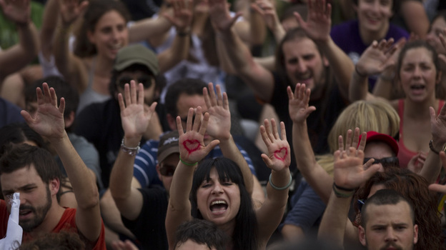 Demonstrators shout slogans during a protest to mark the anniversary of the "Indignados" movement in Madrid, Spain on Sunday. Tens of thousands of Spaniards took to the streets to protest the handling of the country's worst crisis in decades.