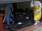 Morgue employees take in some of the bodies that were found Sunday. Morgue employees take in some of the bodies that were found Sunday.
