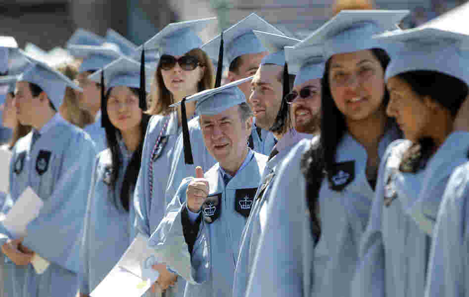 Columbia University janitor Gac Filipaj give a thumbs up during the Columbia University School of General Studies graduation ceremony on Sunday.