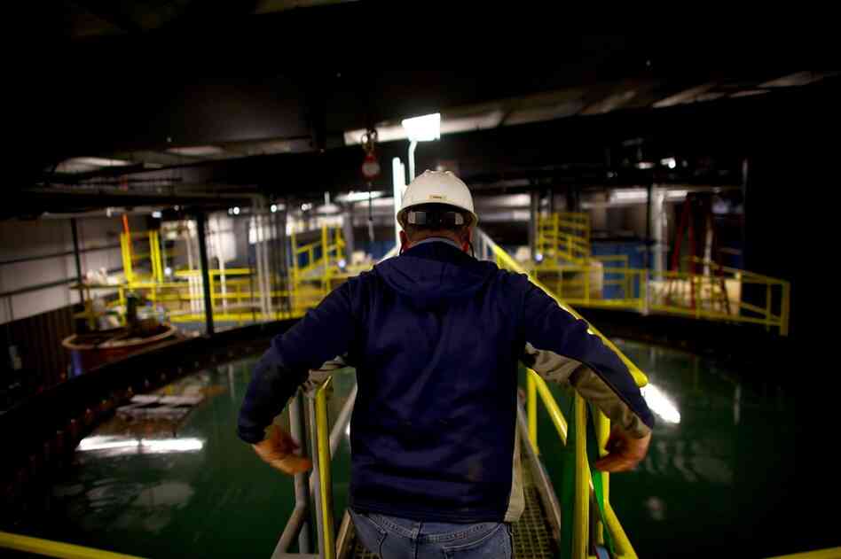 A worker crosses over a water-holding and skimming tank. In 2008, Eureka modified its technology to clean up the peculiar mix of gunk in frack water.