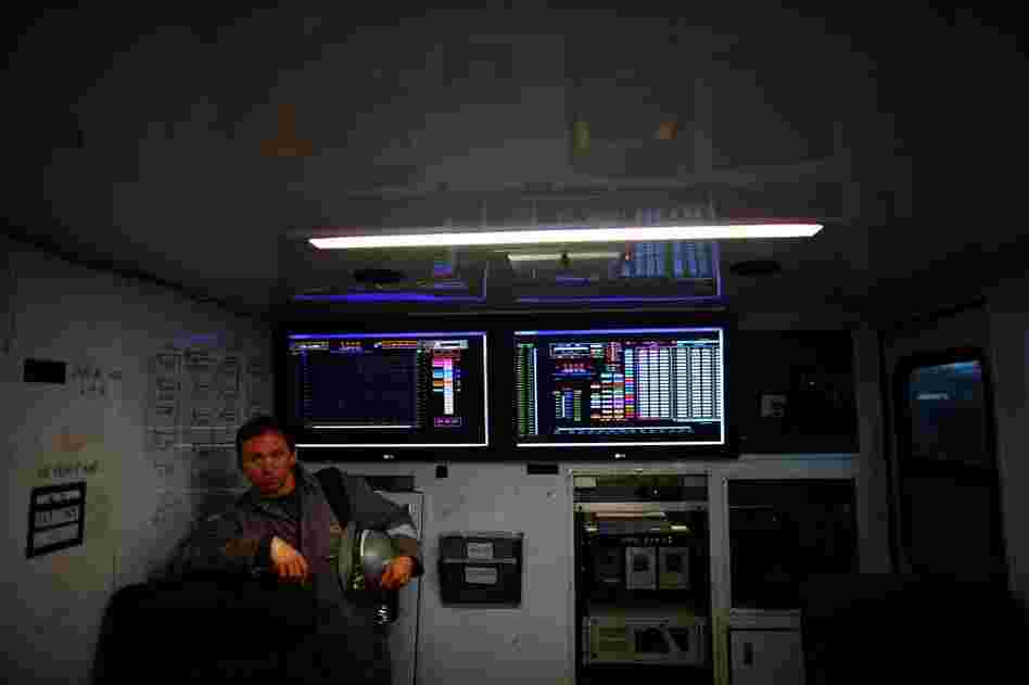 A Chesapeake Energy worker stands next to the control panel that monitors the fracking process.