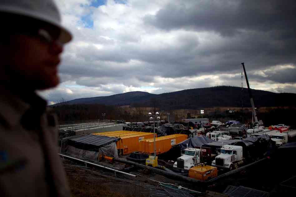 Rory Sweeney of Chesapeake Energy looks over an active drilling site. Millions of gallons of fluid help crack open fractures in shale, releasing trapped gas.