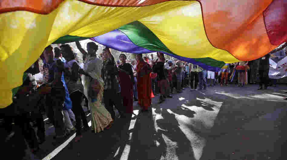 Participants carry a rainbow flag during a gay, lesbian, bisexual and transgender parade in Mumbai, India.