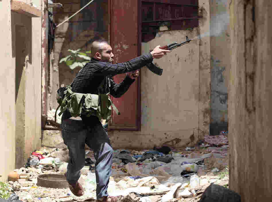 A Sunni gunman fires during clashes in the northern port city of Tripoli, Lebanon on Monday.