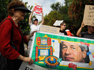 Protesters are seen behind a banner with a picture of JPMorgan Chairman and CEO Jamie Dimon outside a shareholders meeting Tuesday in Tampa, Fla. Protesters are seen behind a banner with a picture of JPMorgan Chairman and CEO Jamie Dimon outside a shareholders meeting Tuesday in Tampa, Fla.