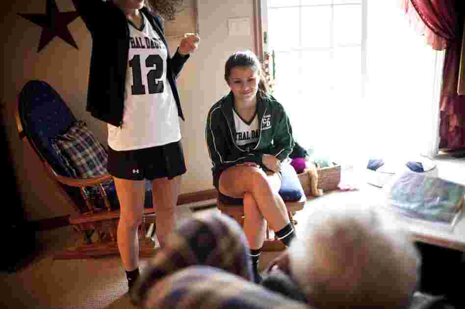 Carley, 17, chats with AnnaBelle, whom the family affectionately calls "Snootzie," after returning from lacrosse practice.