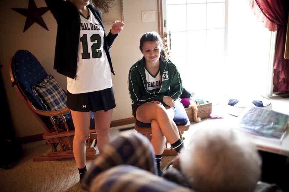 Carley, 17, chats with AnnaBelle, whom the family affectionately calls "Snootzie," after returning from lacrosse practice.