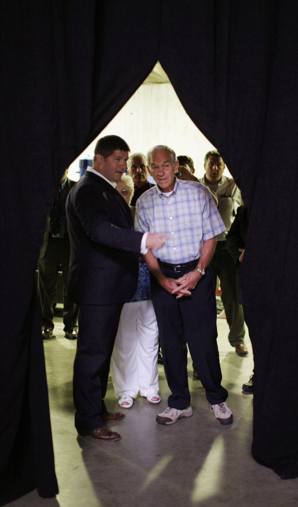 Rep. Ron Paul, R-Texas (right), talks with chief strategist Jesse Benton in Ames, Iowa, on Aug. 13.