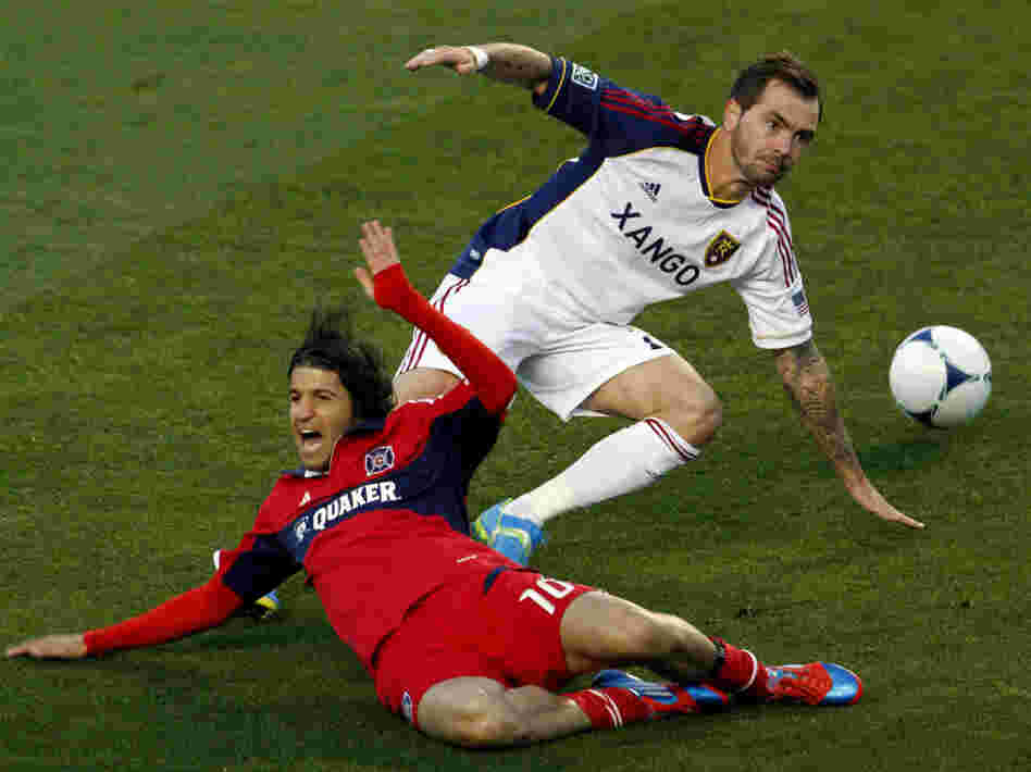 Real Salt Lake's Jonny Steele (right) trips Chicago Fire's Sebastian Grazzini during a Major League Soccer matchup. The game ended without a score — one of 11 ties each MLS team is likely to record this season.