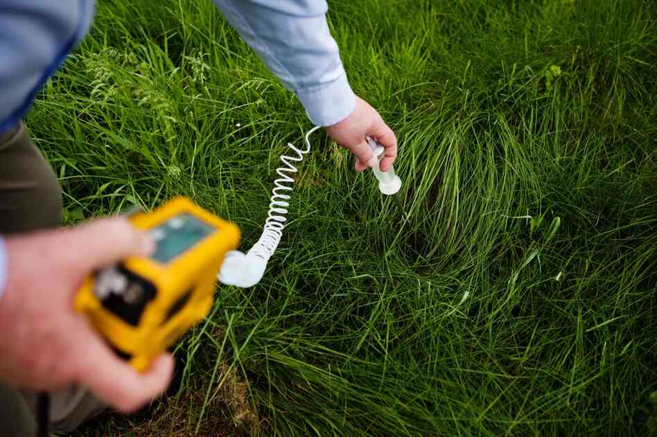 Dr. Michael McCawley tests soil samples outside the clinic for elevated levels of pollutants.