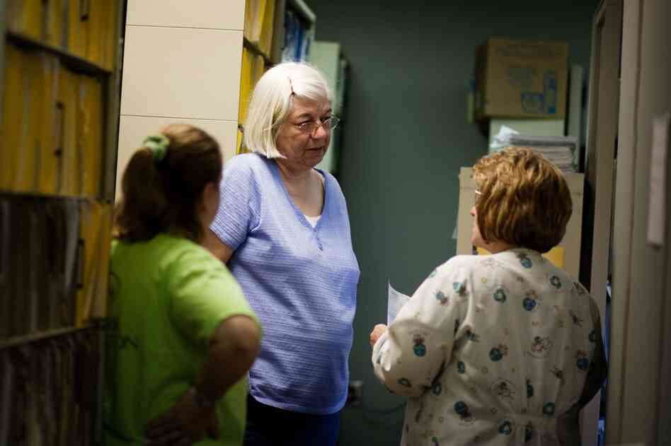 Cornerstone nurse Kay Allen (center) talks with her co-workers. Some staffers stopped coming into the clinic because of the fumes.