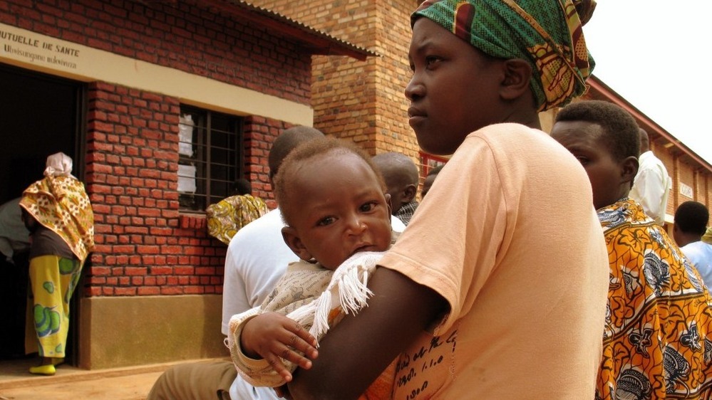 A mother and child wait to receive treatment at the HIV clinic in Nyagasambu, Rwanda, in Feb. 2008. The clinic was built by the Washington-based Elizabeth Glaser Pediatric AIDS Foundation with a grant from the PEPFAR program.