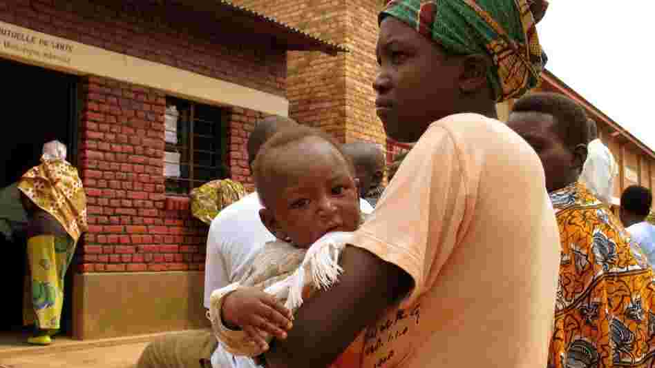 A mother and child wait to receive treatment at the HIV clinic in Nyagasambu, Rwanda, in Feb. 2008. The clinic was built by the Washington-based Elizabeth Glaser Pediatric AIDS Foundation with a grant from the PEPFAR program.