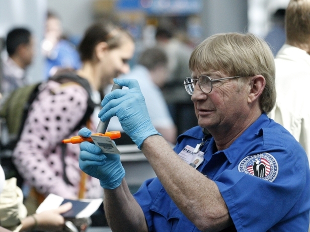 Despite the multiple layers of security at airports, terrorists still often target planes. But terrorism analysts say they are also concerned about soft targets. Here, a Transportation Security Administration agent looks at an identity card at the Portland International Airport earlier this month.