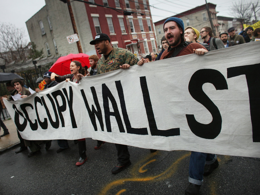Occupy Wall Street protesters march through in an impoverished community in December 2011.