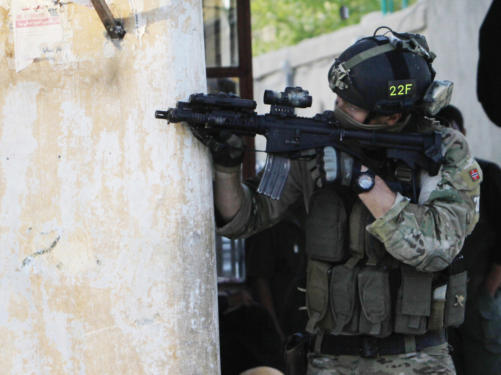 A NATO soldier aims his weapon during a gun battle in Kabul, Afghanistan, in April. NATO is holding a summit in Chicago this weekend, and discussing the future of the alliance is on the agenda.
