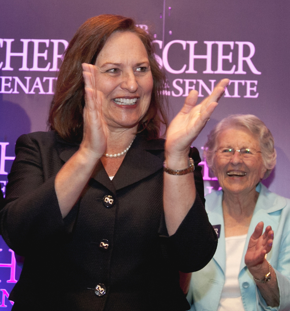 Nebraska state Sen. Deb Fischer applauds supporters at her election party Tuesday in Lincoln, Neb. At right is Fischer's mother, Florence Strobel.