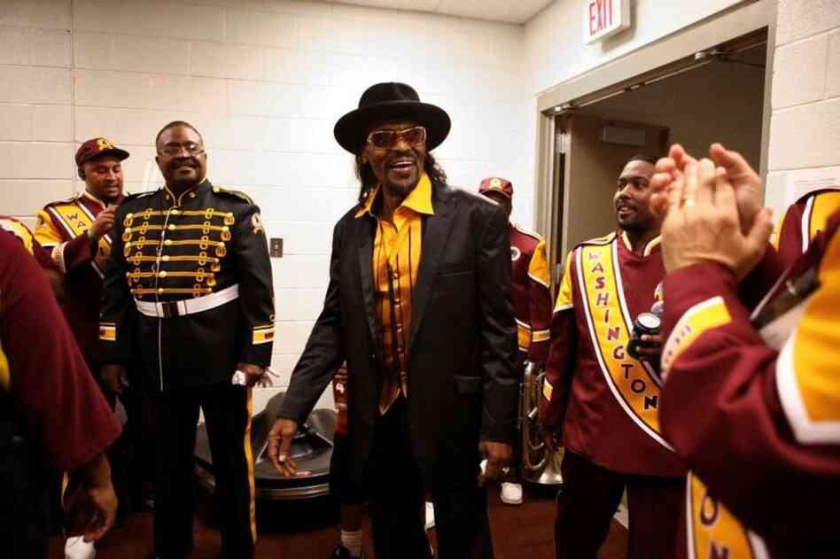 Brown became a fixture at events in the nation's capitol. Here, he greets members of the Washington Redskins Marching Band before a game in 2010. 