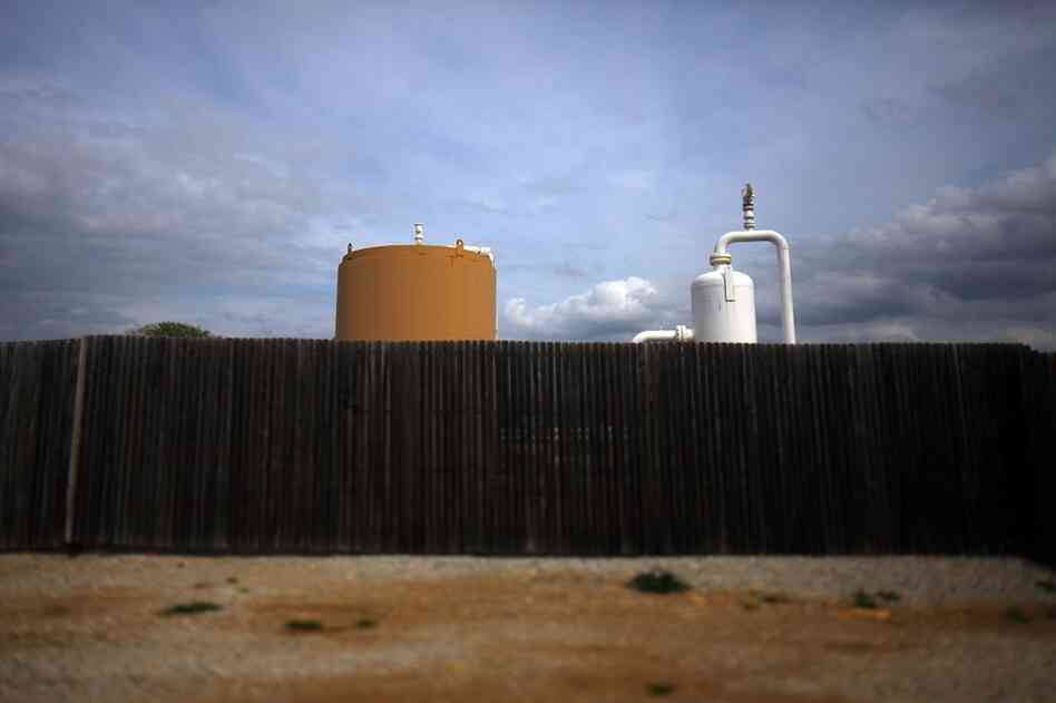 Energy companies surround some well sites with wooden fencing to cut down on the industrial feel of their operations.