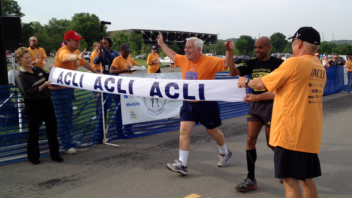 Sen. Dick Lugar, R-Ind., crosses the finish line of the 3-mile Capital Challenge charity race with Olympic marathoner Meb Keflezighi. It was Lugar's 31st race, and his last as a senator after he lost a primary challenge this month.