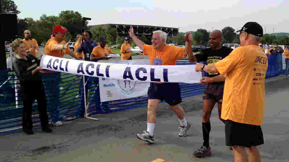 Sen. Dick Lugar, R-Ind., crosses the finish line of the 3-mile Capital Challenge charity race with Olympic marathoner Meb Keflezighi. It was Lugar's 31st race, and his last as a senator after he lost a primary challenge this month.