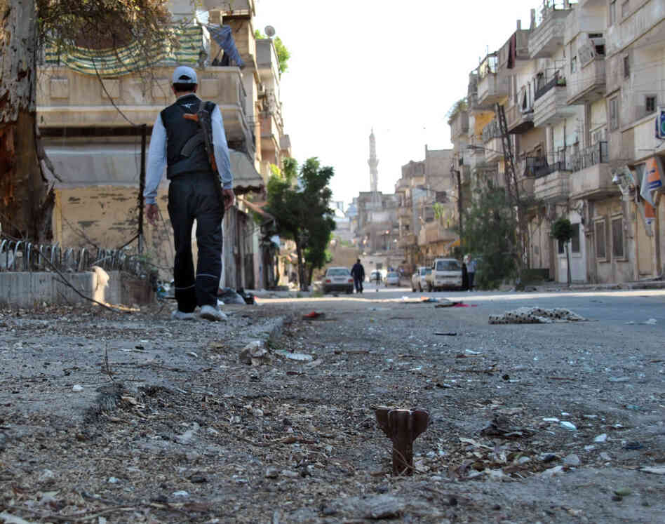 A Syrian rebel walks in Khaldiyeh neighborhood in Homs province, central Syria on Tuesday.