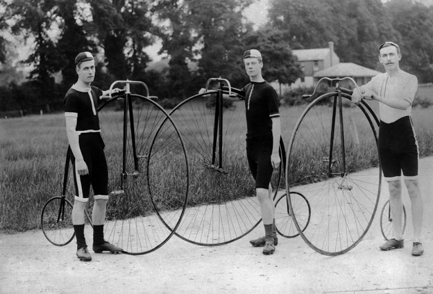 Three men stand with their penny farthing bicycles. Follow their example for Bike to Work Day, and take a photo of yourself and your bike. Then, post the photo to Twitter or Instagram, with the hashtag #NPRbike.