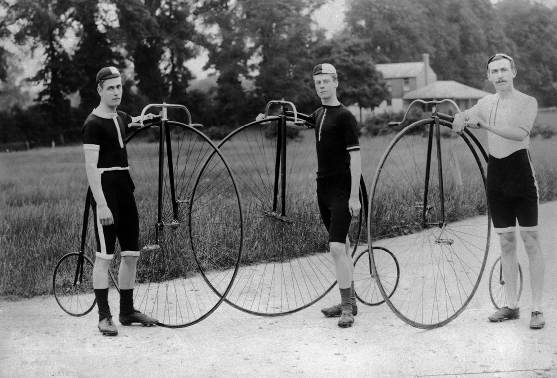 Three men stand with their penny farthing bicycles. Follow their example for Bike to Work Day, and take a photo of yourself and your bike. Then, post the photo to Twitter or Instagram, with the hashtag #NPRbike.