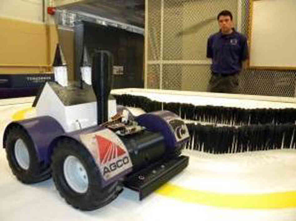 Brent Ware, a member of the robotics team at Kansas State, stands next to a planting robot that won a national competition. Brent Ware, a member of the robotics team at Kansas State, stands next to a planting robot that won a national competition.