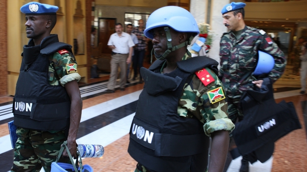 U.N. monitors in Syria leave their Damascus hotel on Wednesday on a mission. A day earlier, their U.N. colleagues were at the scene of a major clash in northern Syria that left more than 30 Syrians dead.