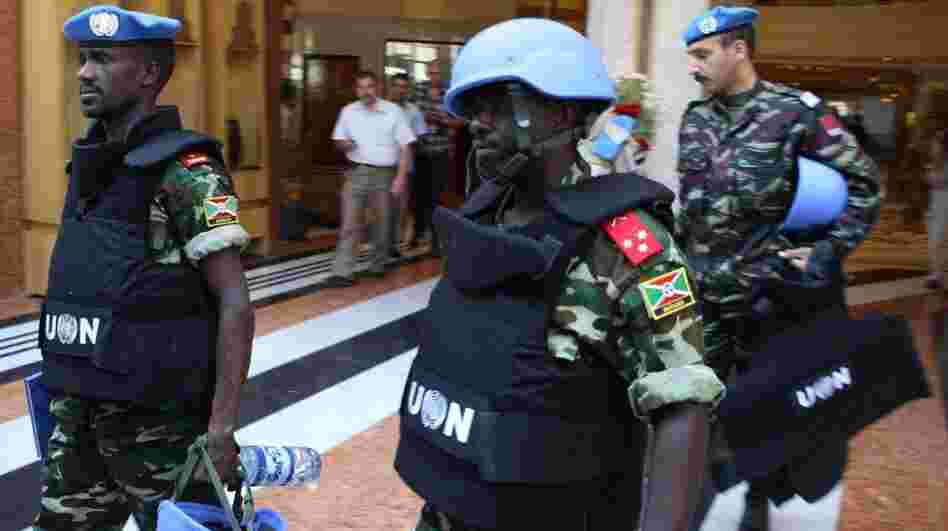 U.N. monitors in Syria leave their Damascus hotel on Wednesday on a mission. A day earlier, their U.N. colleagues were at the scene of a major clash in northern Syria that left more than 30 Syrians dead.