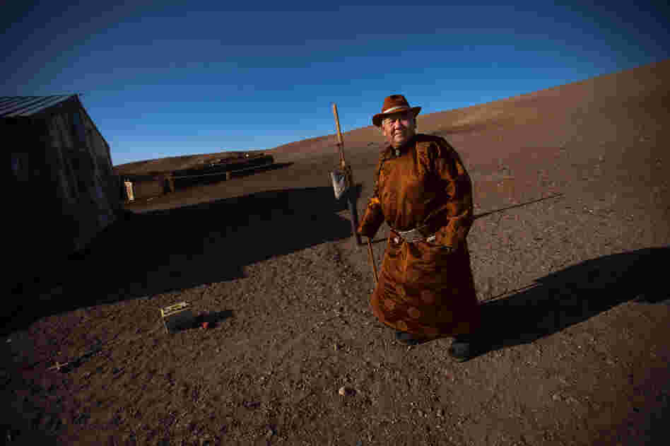 Herder Mijiddorj Ayur, 76, stands outside his home in South Gobi, Mongolia. He worries about the effects a local mine will have on his livelihood.