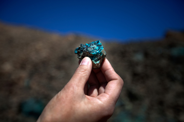 The mine at Oyu Tolgoi, Turquoise Hill in Mongolian, will be one of the world's largest copper mines in about five years. An employee holds up a small sample of the oxidized copper that gave the mine its name.