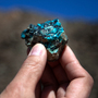 The mine at Oyu Tolgoi, Turquoise Hill in Mongolian, will be one of the world's largest copper mines in about five years. An employee holds up a small sample of the oxidized copper that gave the mine its name.