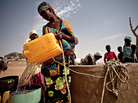 A woman refills her bucket from a well in the south of Mauritania. The Sahel region, south of the Sahara, is facing a third season of drought. A woman refills her bucket from a well in the south of Mauritania. The Sahel region, south of the Sahara, is facing a third season of drought.