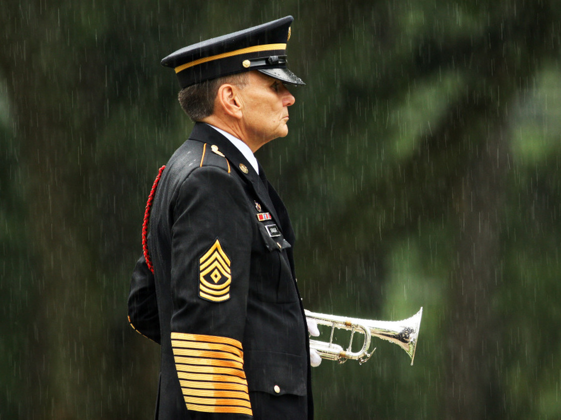 A lone bugler stands at attention in the rain at Wilmington National Cemetery in North Carolina, in 2009.
