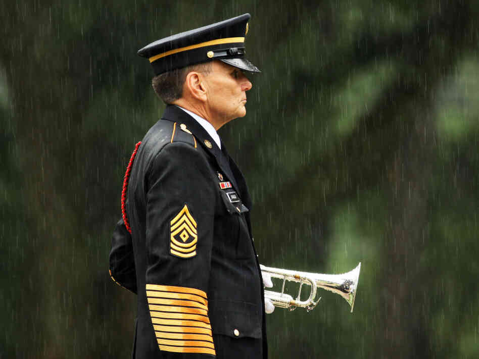 A lone bugler stands at attention in the rain at Wilmington National Cemetery in North Carolina, in 2009.
