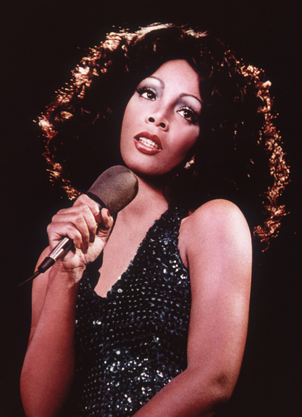 Disco singer Donna Summer singing on stage around 1975.
