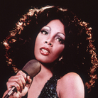 Disco singer Donna Summer singing on stage around 1975. Disco singer Donna Summer singing on stage around 1975.