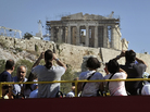 Greece depends heavily on tourism, but the economic crisis is driving away visitors like these ones photographing the Acropolis in Athens from the top of a tour bus last October. Greece depends heavily on tourism, but the economic crisis is driving away visitors like these ones photographing the Acropolis in Athens from the top of a tour bus last October.