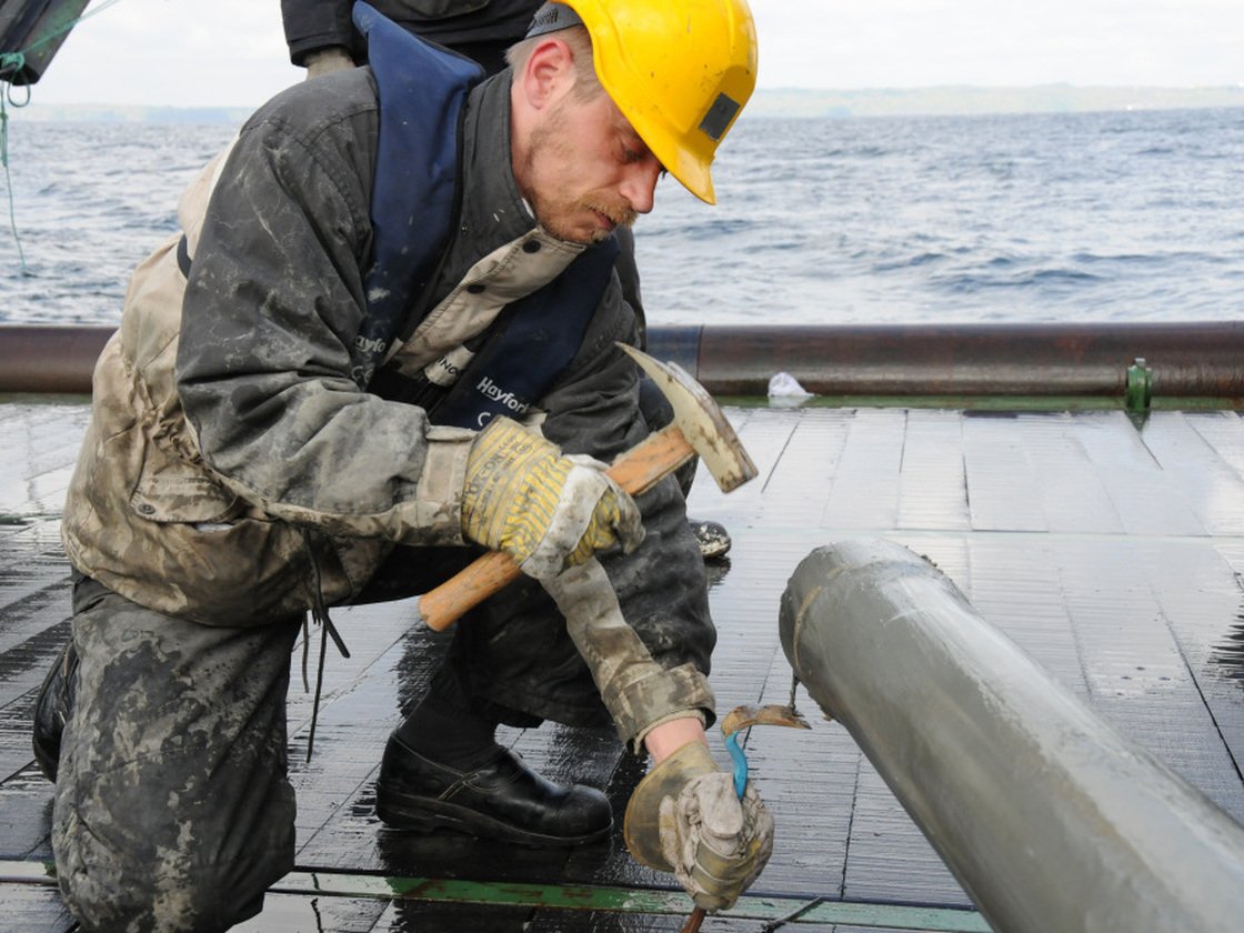 Researcher Hans Roy opens a core sample taken from the bottom of the Pacific Ocean. A core sample like this one contained bacteria that settled on the seafloor 86 million years ago.
