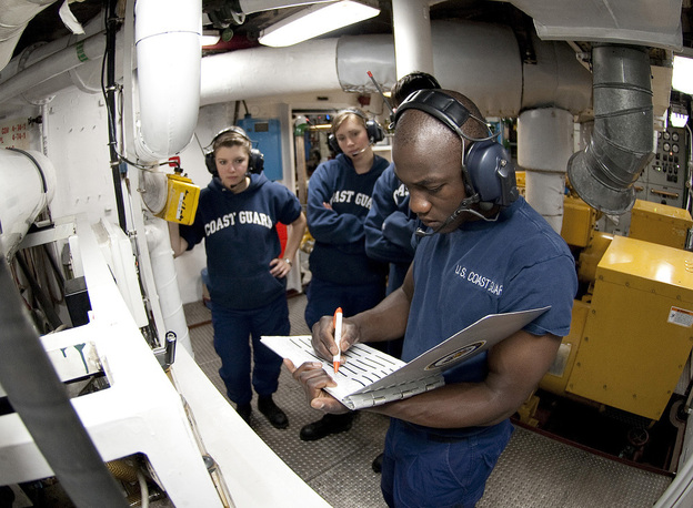 U.S. Coast Guard Academy Cadet Orlando Morel reviews a logbook in the generator room aboard the Coast Guard Cutter Eagle on June 23. Morel was 6 years old when he and his mother were rescued by the Coast Guard while leaving Haiti. Morel graduated Wednesday from the academy in New London, Conn.