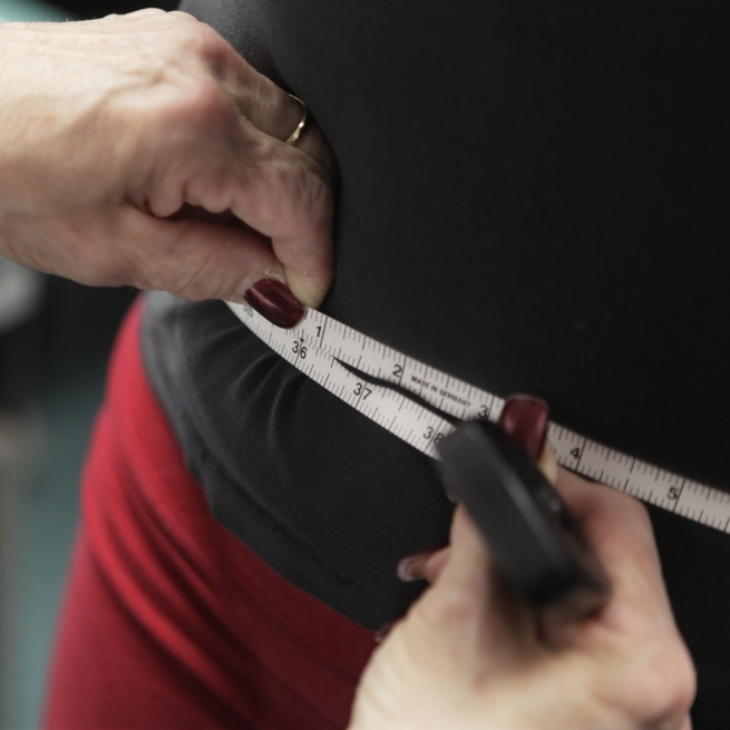 Paris Wood, 14, has her measurements taken as part of a Chicago anti-obesity program.