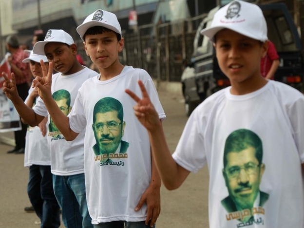 Among the candidates in Egypt's presidential election is Mohammed Mursi of the Muslim Brotherhood. Here, his young supporters campaign for him on the outskirts of Cairo on Thursday.