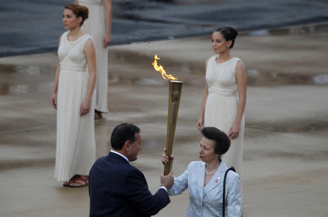 President of the Greek Olympic Committee Spyros Kapralos passes the torch to Britain's Princess Anne, right. President of the Greek Olympic Committee Spyros Kapralos passes the torch to Britain's Princess Anne, right.